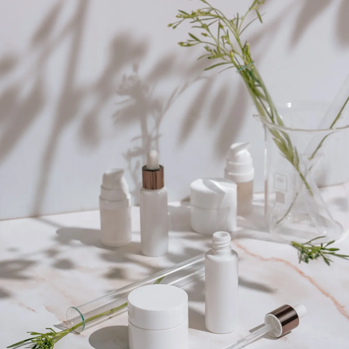 cosmetic-products-white-packaging-laboratory-glassware-science-skincare-concept
